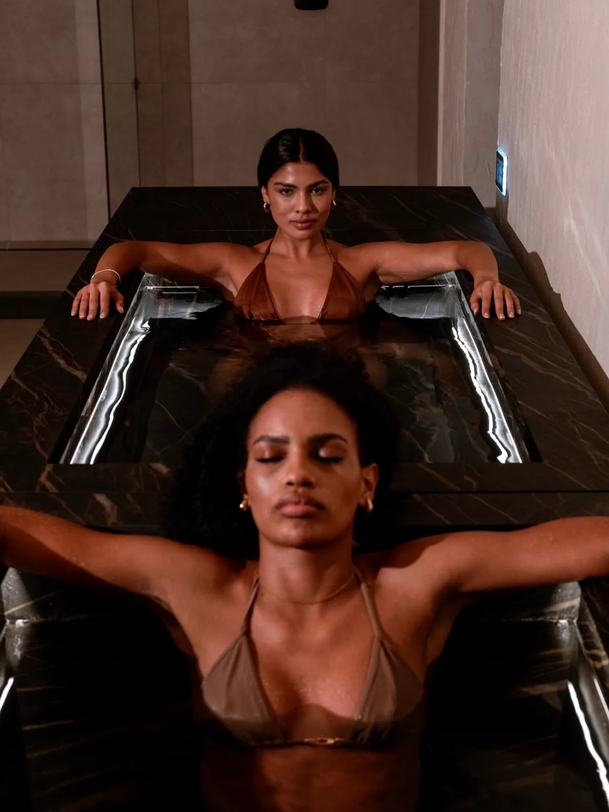 Cold Plunge — dark stone cold plunge pools at the club