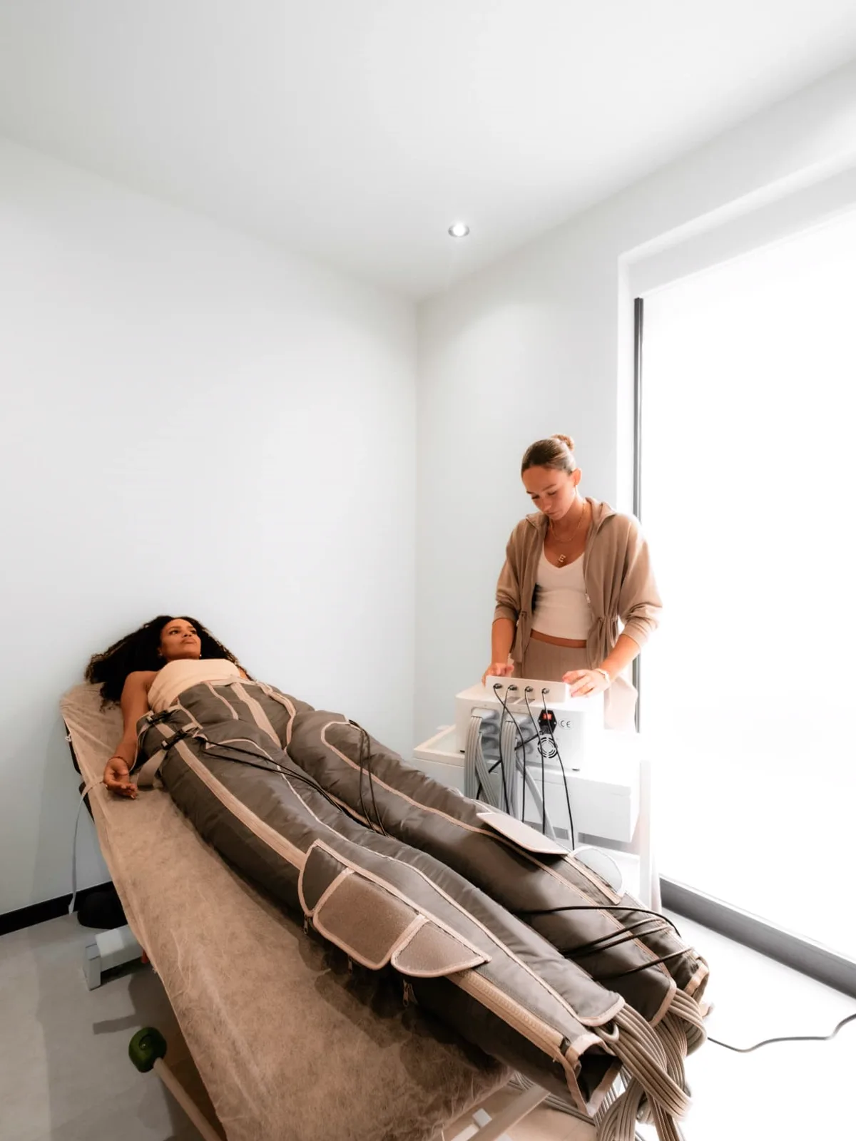 Whole Body Compression — full-body compression therapy suit on a treatment bed